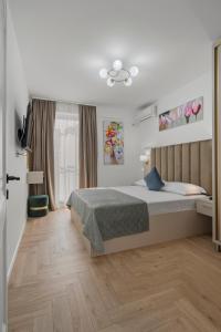 a bedroom with a bed and a ceiling at Luxury Apartments - Boutique Hotel - Central Location in Bucharest
