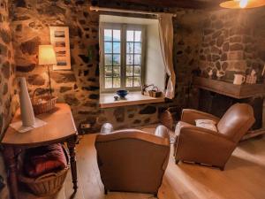 - un salon avec des chaises, une table et une fenêtre dans l'établissement Cozy Countryside Escape in Auvergne, à Vachelerie