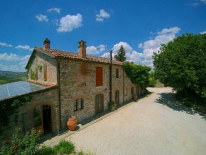 an old stone building with a solar panel on it at Exquisite Villa in San Venanzo with Private Pool in San Venanzo