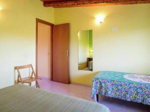 a bedroom with two beds and a mirror at Holiday Home in Sciacca with Garden, Swimming Pool, Parking in Cartabubbo
