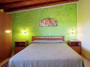 a bedroom with a bed and a green wall at Holiday Home in Sciacca with Garden, Swimming Pool, Parking in Cartabubbo