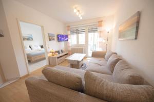 a living room with a couch and a bedroom at Ferienwohnung Boje 9 in Schillig