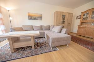 a living room with a couch and a table at Ferienwohnung Boje 9 in Schillig