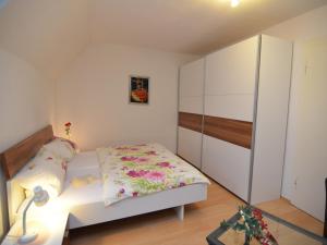 a small bedroom with a bed and a cabinet at Apartment near ski area in Wehrstapel in Sauerland in Meschede +116 photos