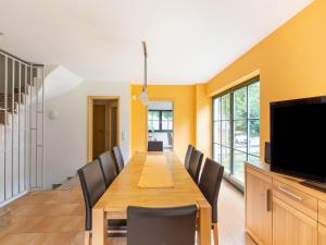 a dining room with a long table and chairs at Spacious semi-detached house with wood stove located directly on the Rennsteig in Eisfeld