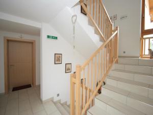 a staircase in a home with a wooden stair case at Spacious Apartment in Uderns near Ski Area in Uderns +134 photos