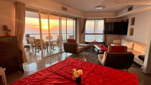 a living room with a view of the ocean at Your BEACH FRONT vacation SUITE in Bat Yam