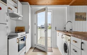 a kitchen with a door leading to a balcony at 4 Bedroom Beautiful Home In Thisted in Torsted