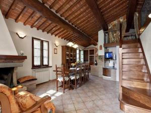 a large living room with a table and a fireplace at Modern Holiday Home in Foiano della Chiana with Pool in Foiano della Chiana