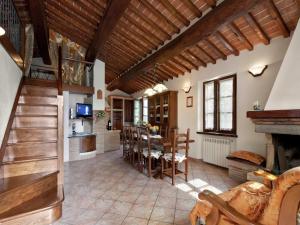 a kitchen and living room with a table and chairs at Modern Holiday Home in Foiano della Chiana with Pool in Foiano della Chiana