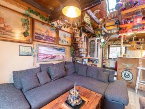 a living room with a couch and a wooden table at Comfortable Apartment in Wismar Mecklenburg with Fireplace in Wismar