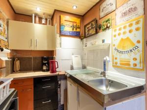 a small kitchen with a sink and a stove at Comfortable Apartment in Wismar Mecklenburg with Fireplace in Wismar