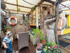 a man standing on a deck in a garden at Comfortable Apartment in Wismar Mecklenburg with Fireplace in Wismar +68 photos