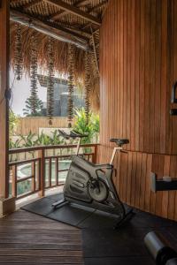 a gym with a treadmill in a room with a balcony at Layla Cabana - 7BR Villa in Pererenan - With Private Pool, Spa, Cinema & Gym in Tumbak Bayuh