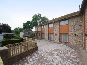 a brick building with a wooden fence in front of it at Spacious Stay with Terrace in Waimes +32 photos