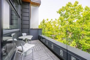 a balcony with tables and chairs on a building at Exclusive 4 Bedroom Townhouse in Toronto