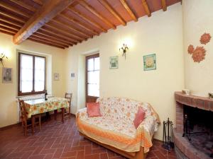 a living room with a couch and a fireplace at Detached villa for 6-pers with outdoor swimming pool in Loro Ciuffenna