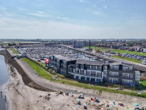 an aerial view of a beach with a parking lot at Unique apartment, located on the Oosterschelde and marina of Sint Annaland in Sint Annaland