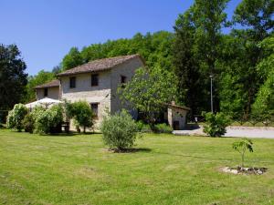 a stone house in a field of grass at Modern Holiday Home in Pietrafitta Umbria with Garden in Pietrafitta