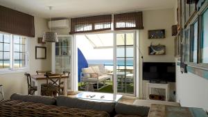 a living room with a couch and a view of the ocean at Lances Beach Penthouses in Tarifa