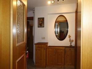 a hallway with a mirror and a wooden cabinet at Apartment in Hippach im Zillertal in the mountains in Mühlen