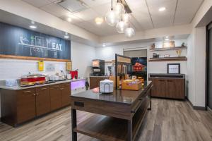 a large kitchen with a table in a room at Hampton Inn & Suites Wilder in Wilder