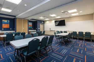 a conference room with tables and chairs and a screen at Hampton Inn & Suites Wilder in Wilder +35 photos