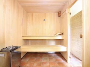 a bathroom with a wooden bench in a room at Holiday resort in the Müritz National Park, Mirow in Mirow +11 photos