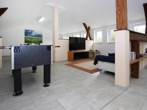 a living room with a flat screen tv and a couch at Holiday resort in the Müritz National Park, Mirow in Mirow