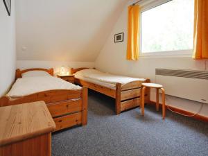 a bedroom with two twin beds and a window at Holiday resort in the Müritz National Park, Mirow in Mirow