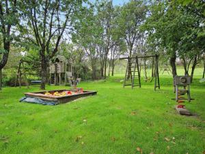 a park with a playground with a fire pit at Holiday resort in the Müritz National Park, Mirow in Mirow +32 photos