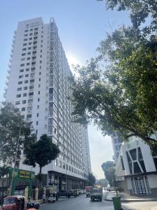 a large tall building on a city street with cars at Apartment for Rent in Phnom Penh