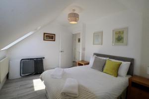 a bedroom with a large bed and a tv at Egham Modern Two Bedroom Apartment in Egham