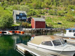 a boat is docked at a dock in the water at 8 person holiday home in Barmen in Barmen