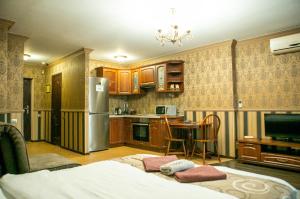 a kitchen with a refrigerator and a table at Doba In Ua Polia27D Apartments in Dnipro