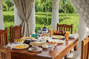 a wooden table with food on top of it at SaffronStays Raj Reverie in Jaipur