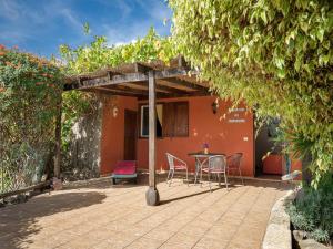 a patio with chairs and a table in front of a house at Holiday home in Malpais de Candelaria with a terrace in Bence