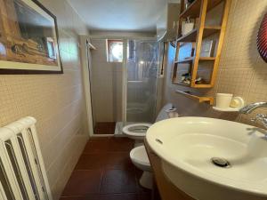 a bathroom with a sink and a toilet at Cottage La Stefania near Anghiari in beautiful setting in Misciano