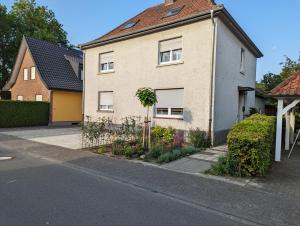 a white house with a tree in front of it at Fewo Steckinghof in Coesfeld