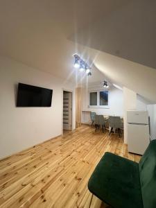 a living room with a television and a table at Casa Lupu 