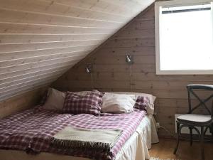 a bedroom with a bed in a attic at 15 person holiday home in Treungen in Treungen