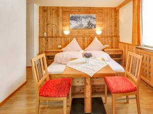 a dining room with a table and chairs at Comfortable apartment in Längenfeld with ski storage in Längenfeld