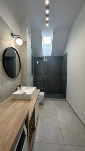 a bathroom with a sink and a toilet and a mirror at ELIZA Apartments - powered by NEO - private parking in Timişoara +140 photos