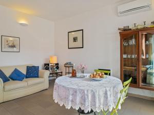 a living room with a table with a bowl of fruit on it at Relaxing Bosa Stay with Veranda in Bosa