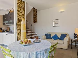 a living room with a table with a bowl of fruit on it at Relaxing Bosa Stay with Veranda in Bosa +33 photos