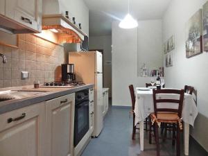 a kitchen with a table and chairs and a refrigerator at Agriturismo Giugnano Poggio del Sole, Lamporecchio in Lamporecchio