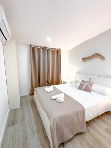 a bedroom with a large bed with towels on it at Casa Romeo - Sea View Apartment in Focene