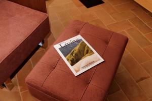 a magazine sitting on top of a brown couch at The Monteleone Umbria Retreat in Monteleone dʼOrvieto