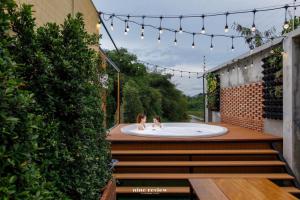 two children are in a bath tub on a patio at The Canale Hat Yai in Hat Yai