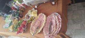 a table topped with different types of meats and vegetables at Wilcza łapa in Pieszyce